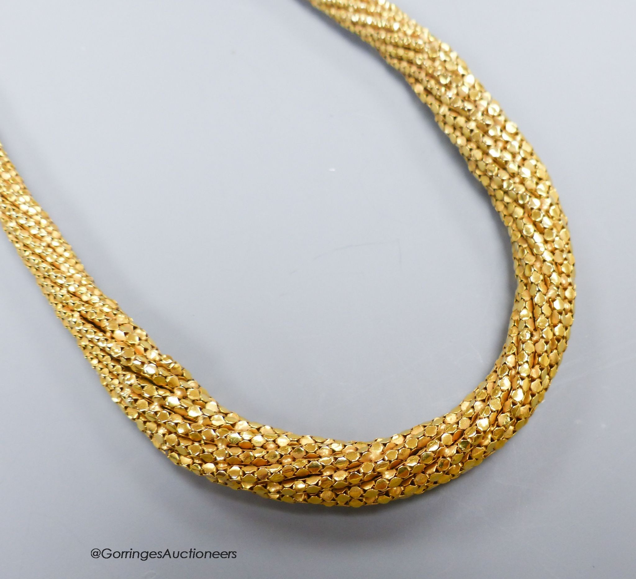 A yellow gold (9kt), flexible close link necklace of tapering form, gross 50g, 43cm.